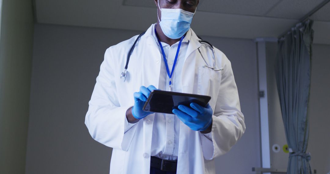 Healthcare Professional Wearing Mask and Gloves Using Tablet - Free Images, Stock Photos and Pictures on Pikwizard.com