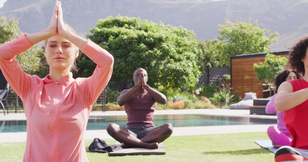 People Practicing Yoga Outdoors Near Pool with Tranquil Background - Free Images, Stock Photos and Pictures on Pikwizard.com