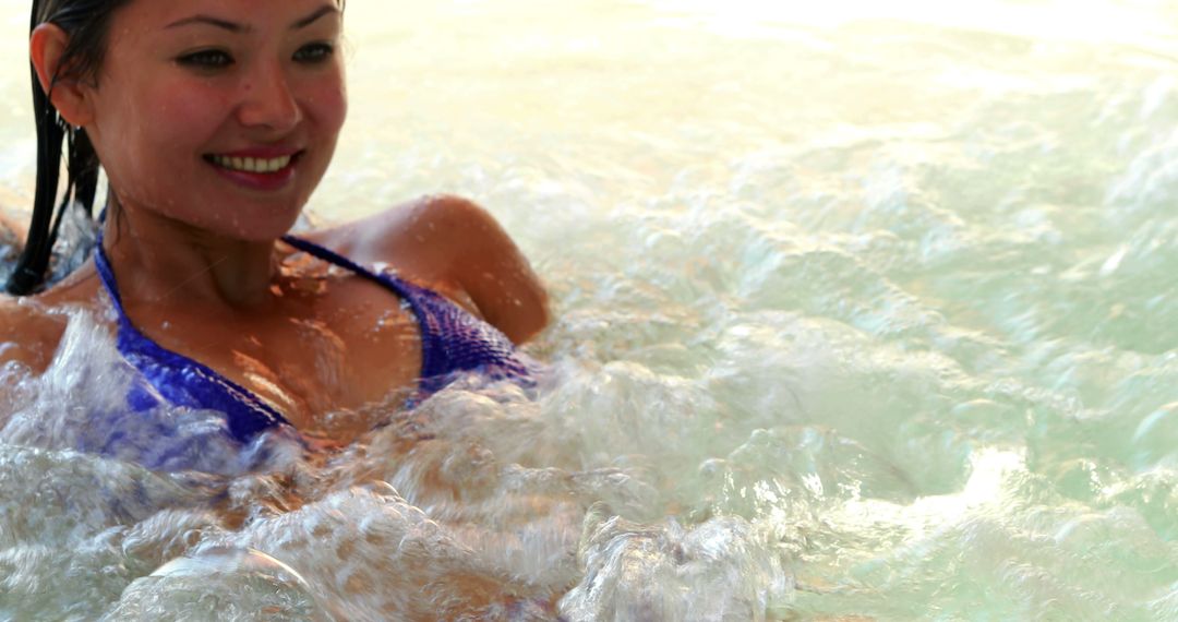 Smiling Woman Relaxing in Jacuzzi with Bubbles - Free Images, Stock Photos and Pictures on Pikwizard.com