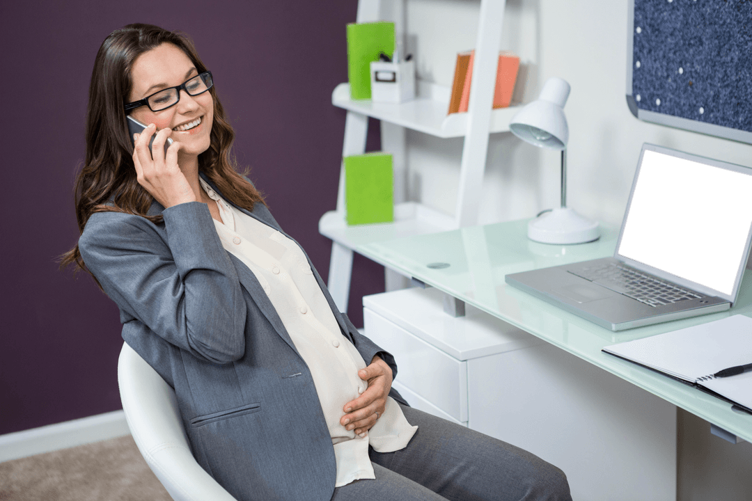 Pregnant Businesswoman on Phone Smiling in Home Office Setting