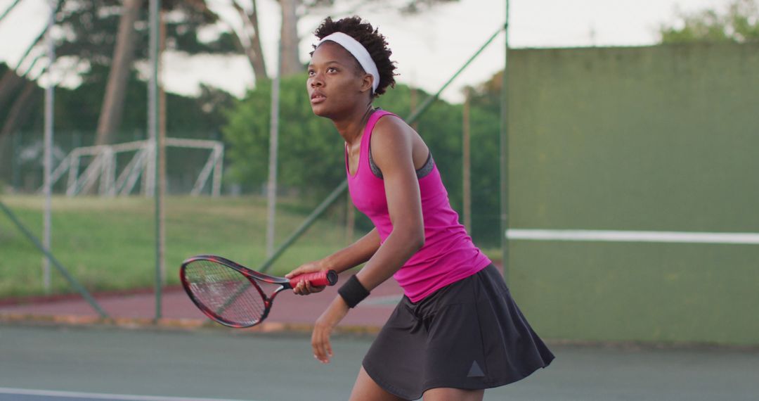 Image of focused african american female tennis player holding racket and hitting ball - Free Images, Stock Photos and Pictures on Pikwizard.com