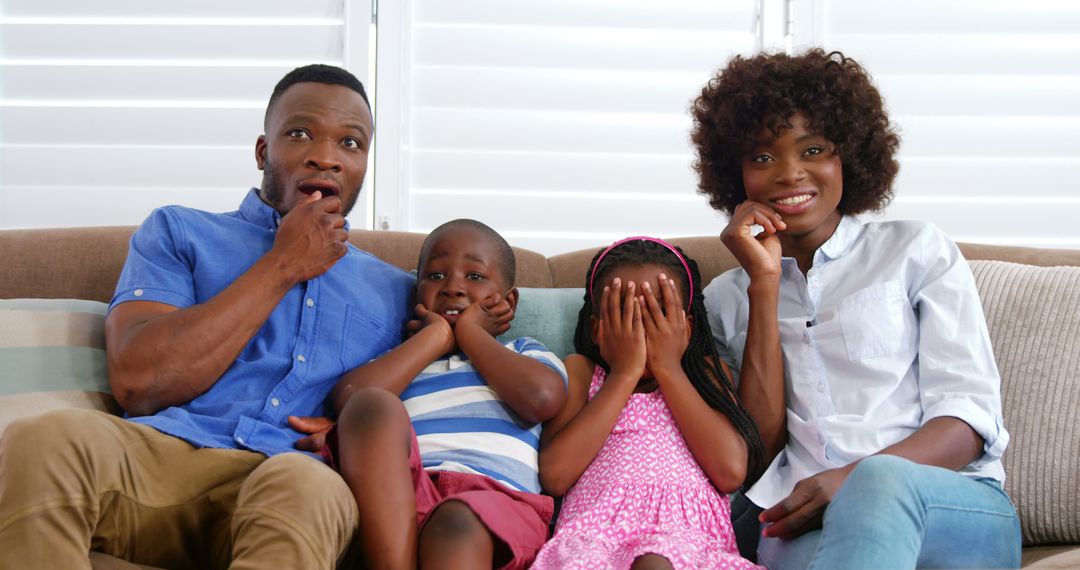 African American Family Watching a Movie Together on Couch - Free Images, Stock Photos and Pictures on Pikwizard.com