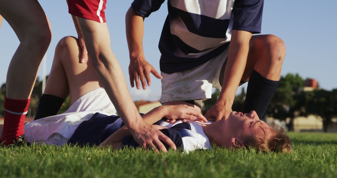 Injured Soccer Player Receiving Assistance on Field - Free Images, Stock Photos and Pictures on Pikwizard.com