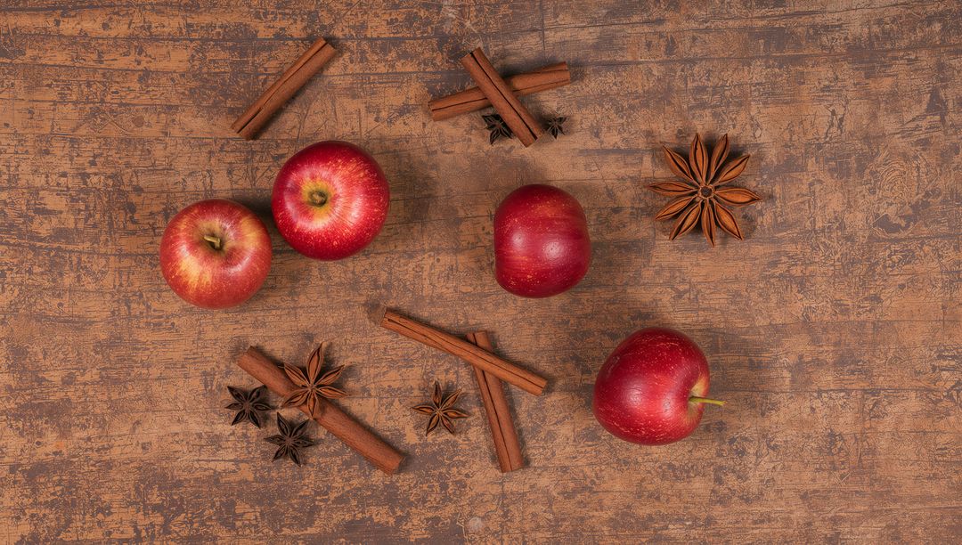Autumn Spice Flatlay Featuring Glossy Red Apples, Cinnamon Sticks and Star Anise