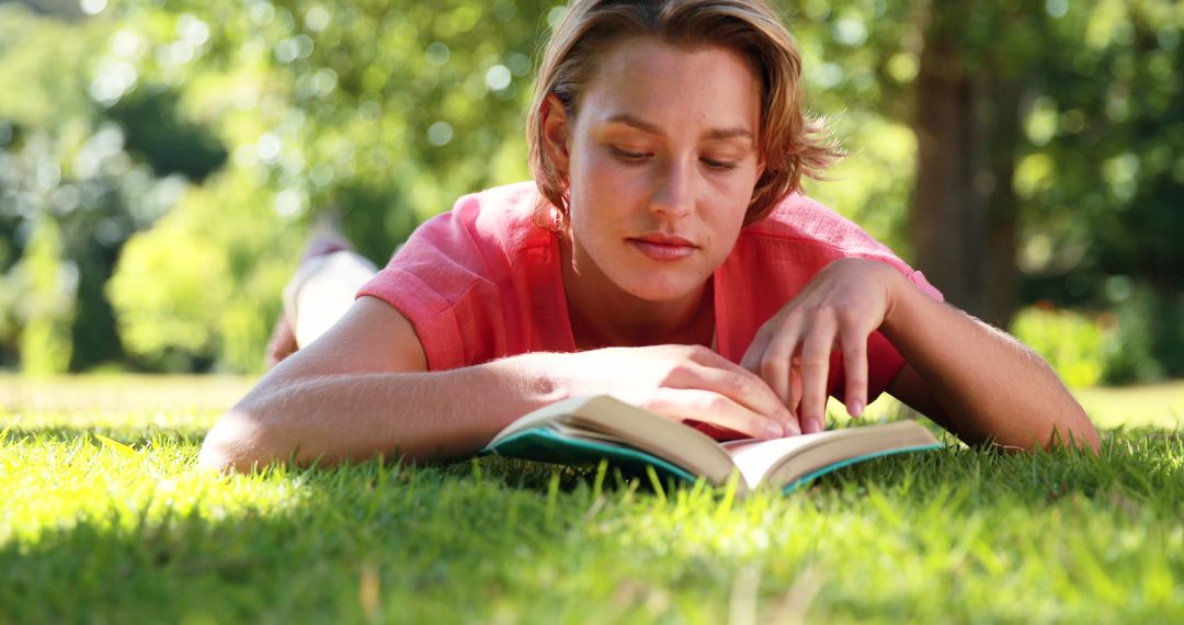 Woman Reading Book on Grass in Sunny Park - Free Images, Stock Photos and Pictures on Pikwizard.com