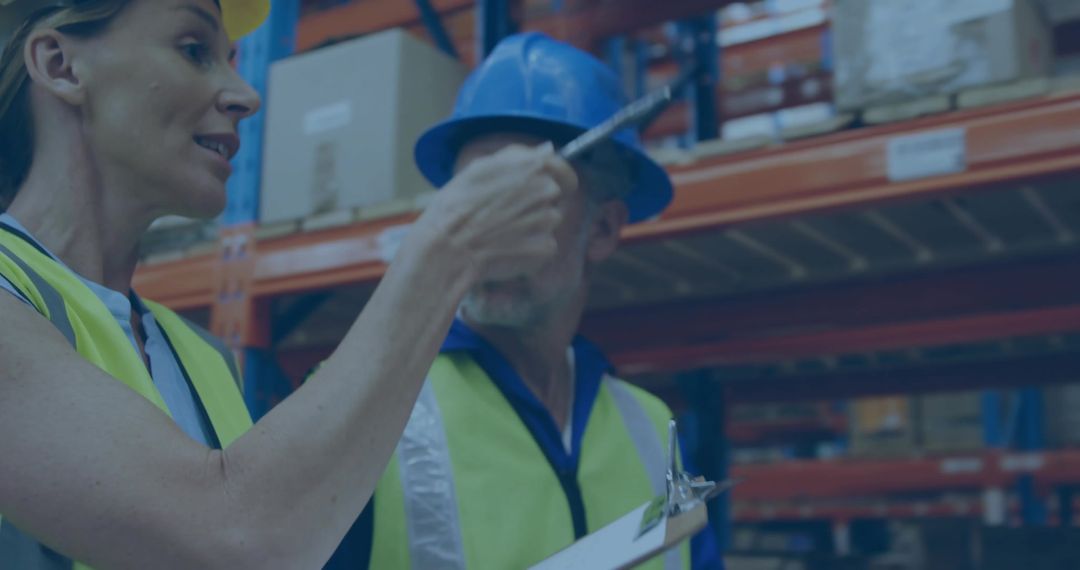Warehouse Workers in Hard Hats Conducting Inventory Check