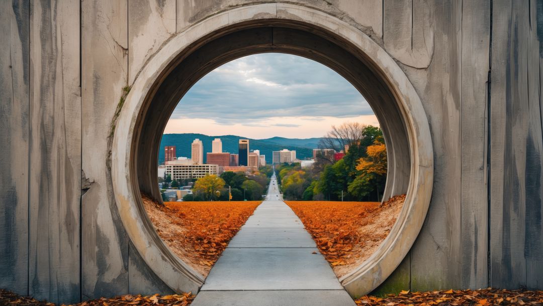 Urban skyline visible through concrete archway on autumn path, knoxville concept