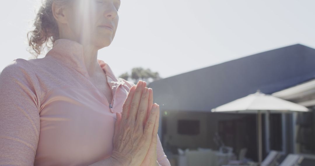 Senior Woman Meditating in Sunlit Garden Setting - Free Images, Stock Photos and Pictures on Pikwizard.com