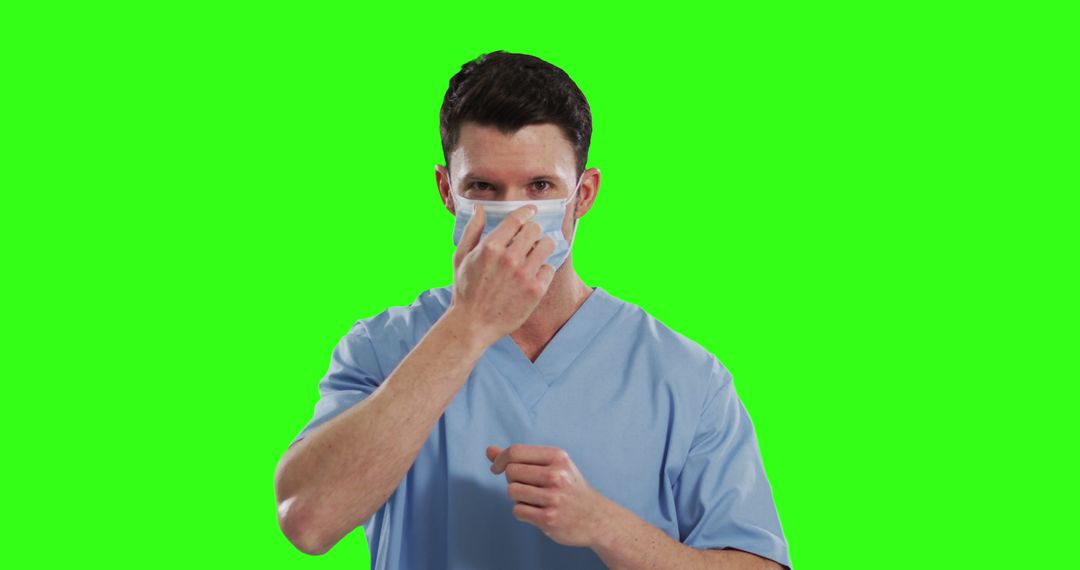 Healthcare Worker Adjusting Face Mask on Green Screen Background - Free Images, Stock Photos and Pictures on Pikwizard.com