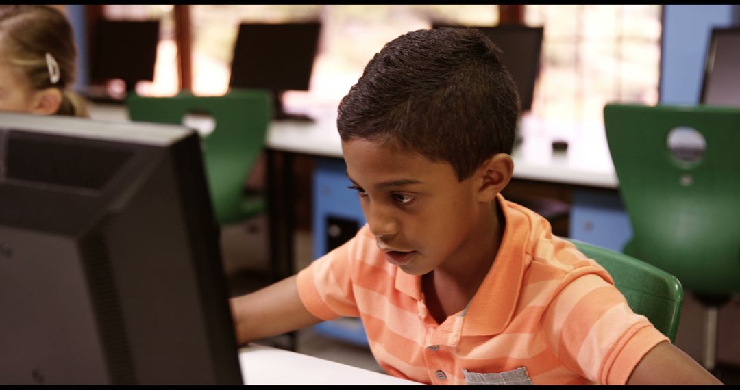 African American Boy Concentrating on Computer in Classroom - Free Images, Stock Photos and Pictures on Pikwizard.com