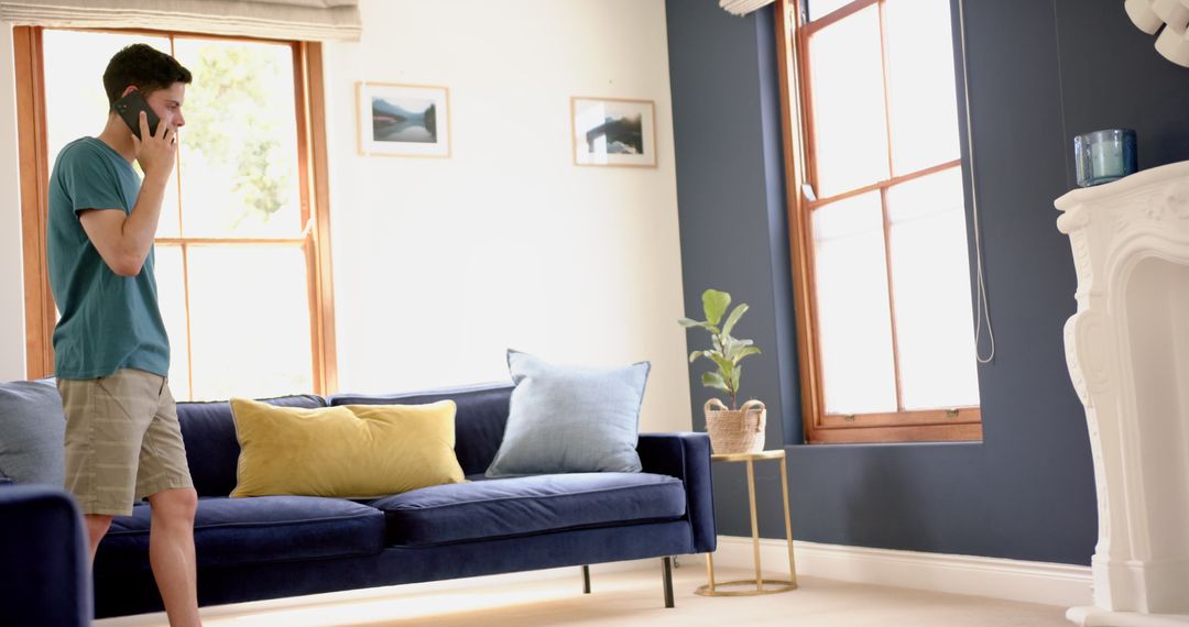 Man Talking on Smartphone Pacing in Comfortable Living Room