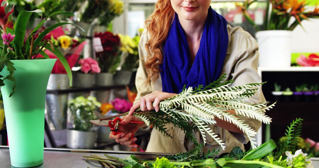 Smiling Florist Arranging Flowers in Shop with Blue Scarf - Free Images, Stock Photos and Pictures on Pikwizard.com