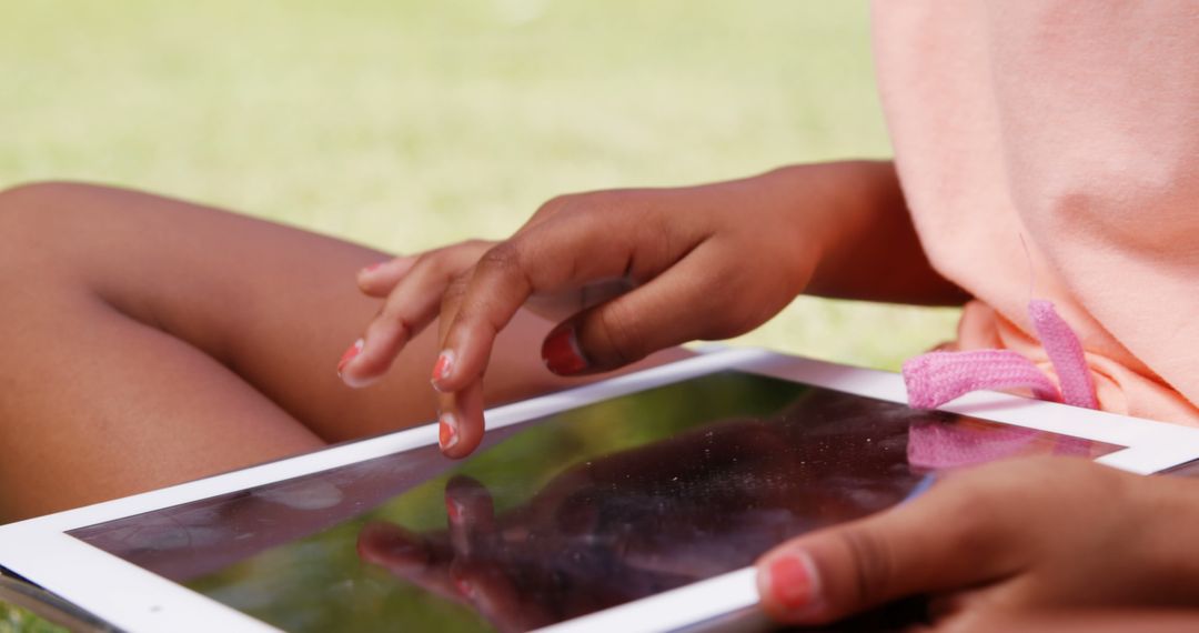 Child Using Tablet Outdoors on Sunny Day - Free Images, Stock Photos and Pictures on Pikwizard.com