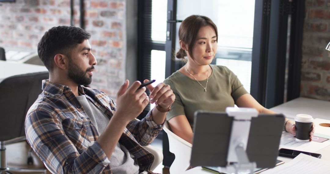 Colleagues Collaborating in Modern Workspace Communication