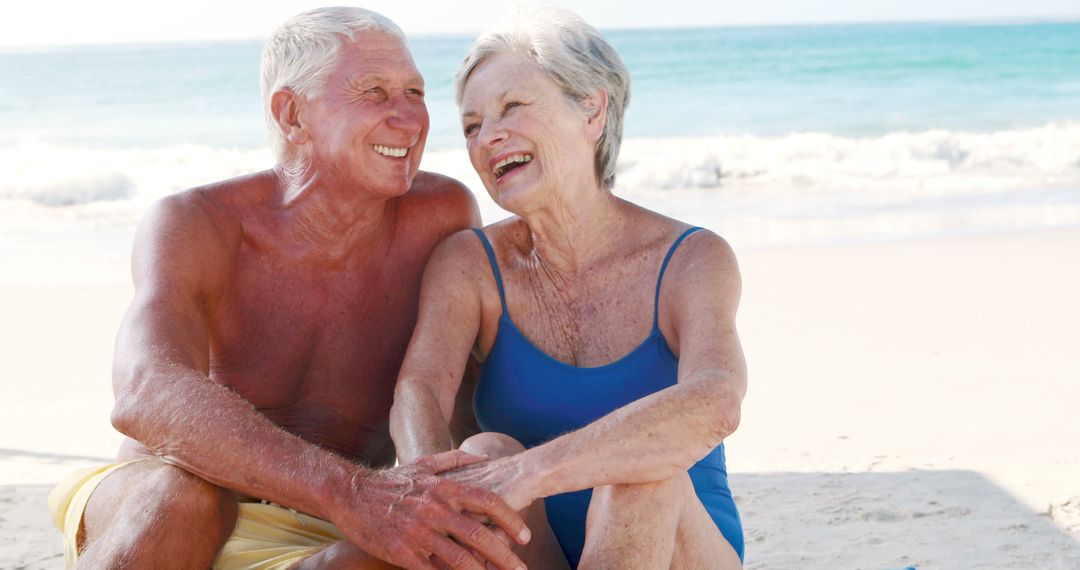 Smiling Senior Couple Enjoying Day at Beach - Free Images, Stock Photos and Pictures on Pikwizard.com