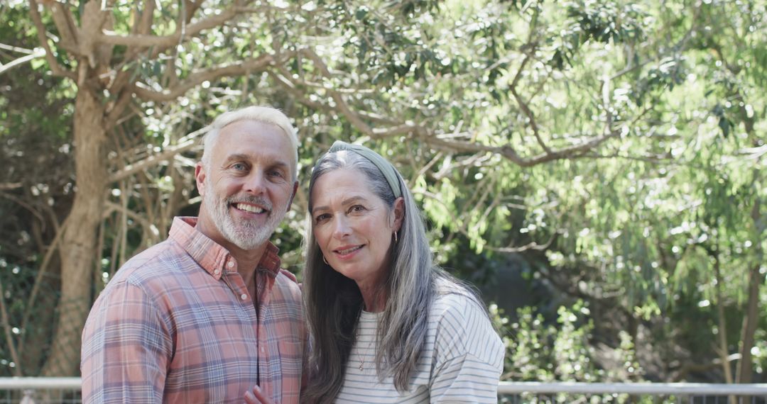 Happy Mature Couple Embracing Outdoors Amid Lush Greenery - Free Images, Stock Photos and Pictures on Pikwizard.com