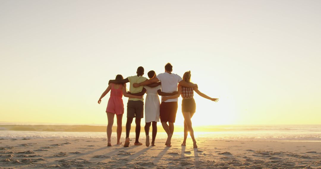 Group of Friends Hugging While Enjoying Beach Sunset - Free Images, Stock Photos and Pictures on Pikwizard.com