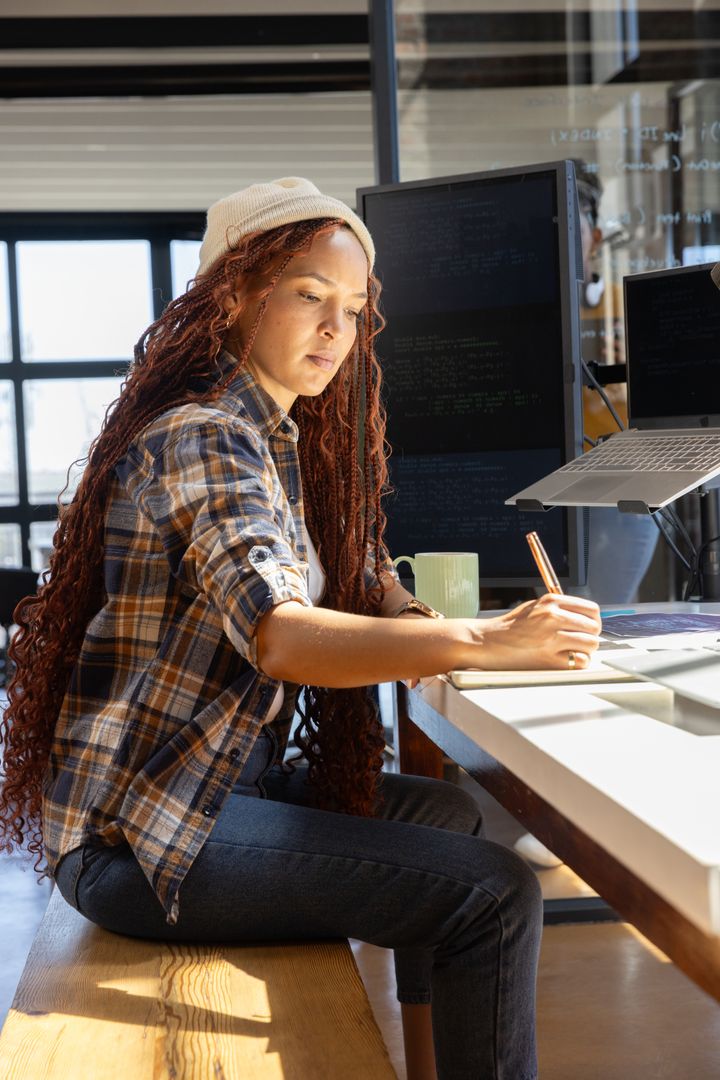 Focused Professional Writing Notes in Modern Office Environment