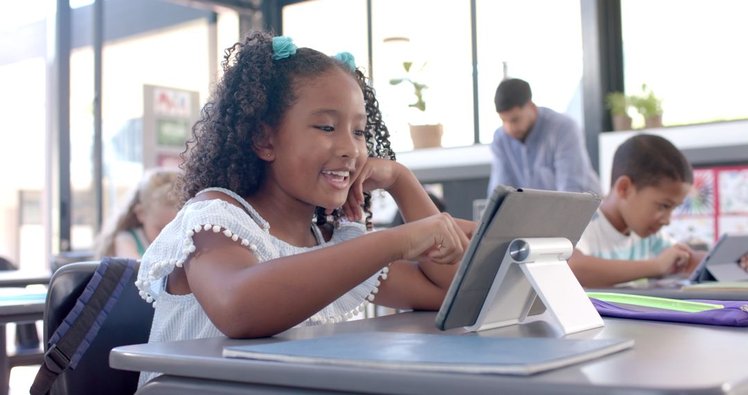 Biracial Girl Engaged with Tablet in Classroom Setting