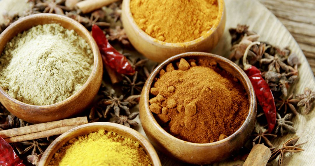 Colorful Assortment of Spices in Wooden Bowls on Round Platter - Free Images, Stock Photos and Pictures on Pikwizard.com