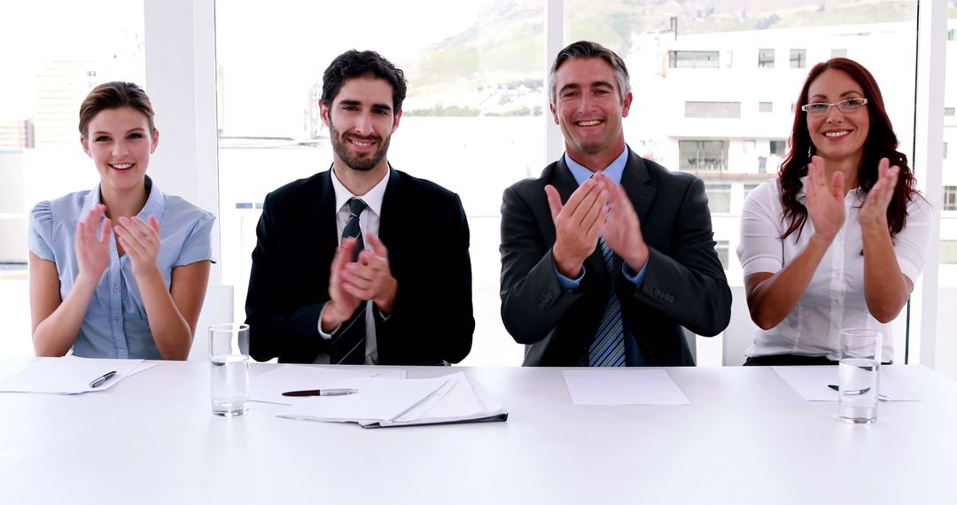 Business Team Applauding in Meeting Room with Documents on Table - Free Images, Stock Photos and Pictures on Pikwizard.com