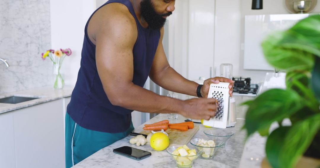 Man in Modern Kitchen Grating Fruit for Healthy Meal Preparation