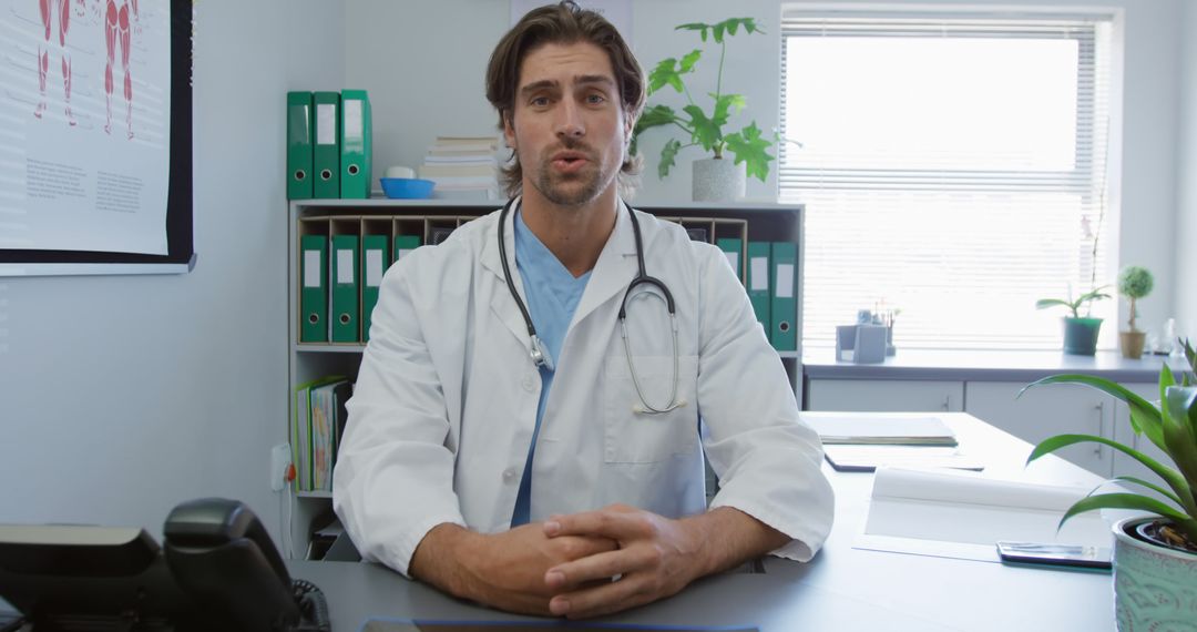 Doctor Sitting at Desk Giving Advice in Medical Office - Free Images, Stock Photos and Pictures on Pikwizard.com