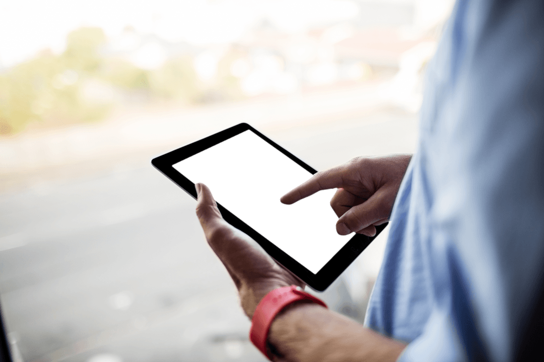 Man Interacting with Transparent Tablet Near Bright Window