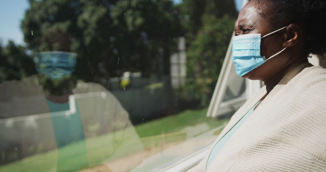 Senior Woman Wearing Mask Looking Out Window During Quarantine - Free Images, Stock Photos and Pictures on Pikwizard.com