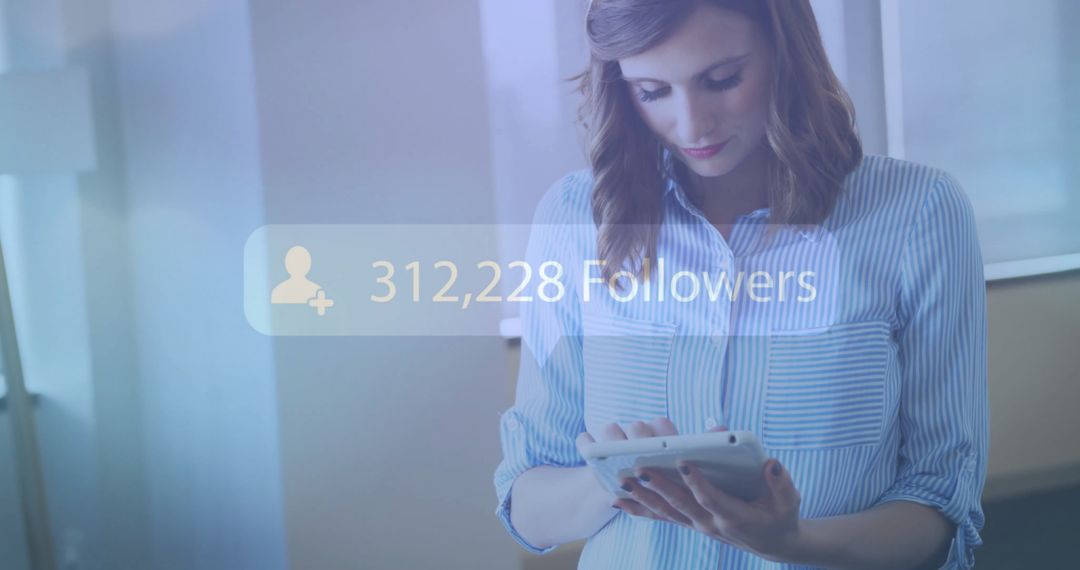 Woman Using Tablet for Social Media Engagement in Office