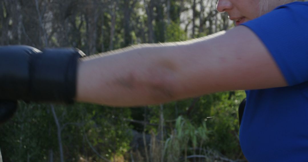 Woman Punching Outside Wearing Black Boxing Gloves - Free Images, Stock Photos and Pictures on Pikwizard.com