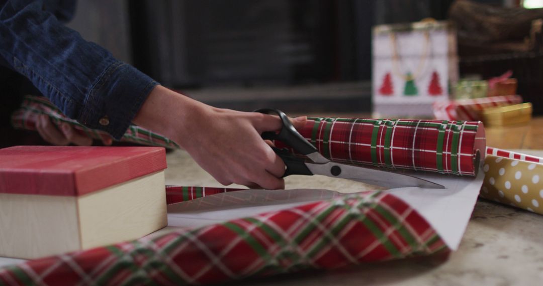 Person Wrapping Christmas Gifts with Red Plaid Paper - Free Images, Stock Photos and Pictures on Pikwizard.com