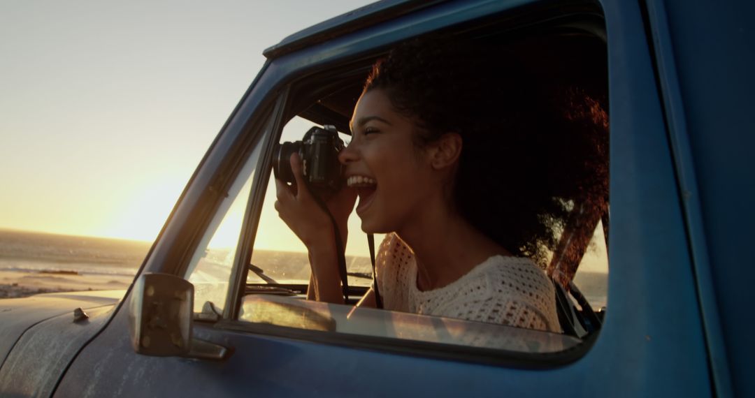 Young Woman Enjoying Scenic Beach Sunset While Taking Photos from Car Window - Free Images, Stock Photos and Pictures on Pikwizard.com