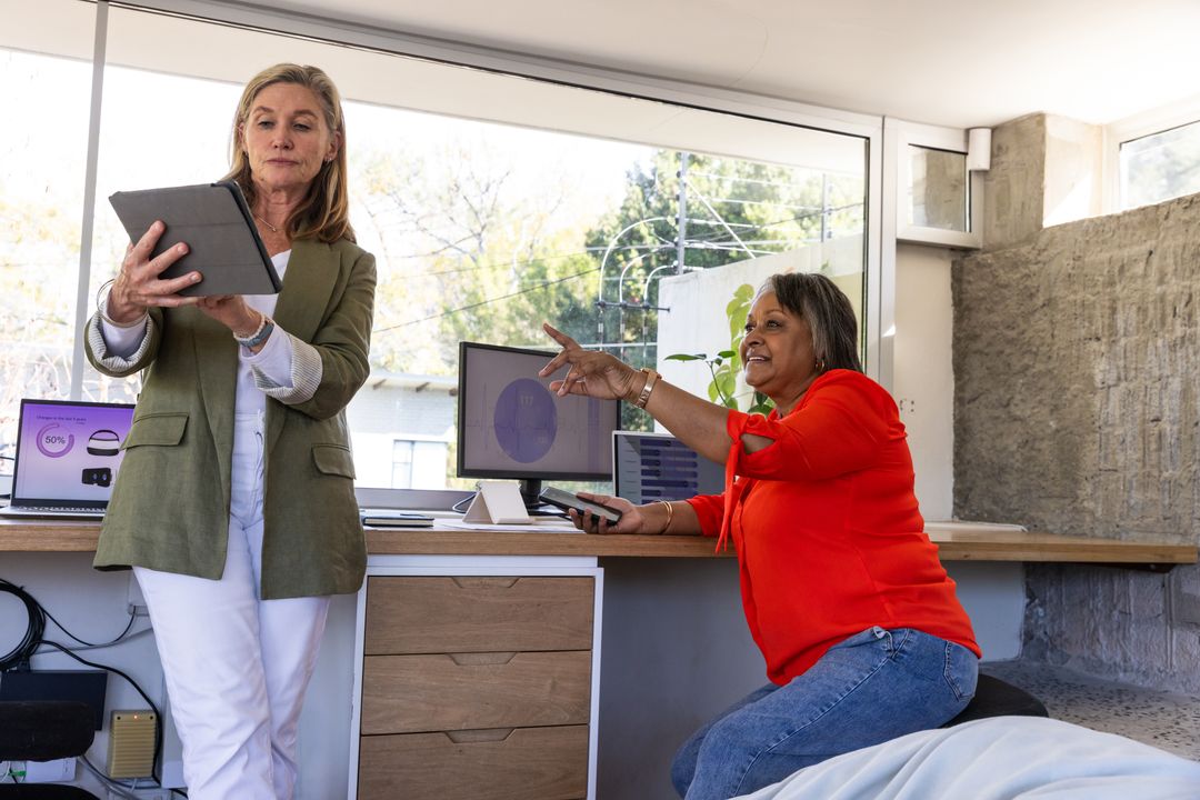 Diverse Female Professionals Collaborating at Modern Office Workspace