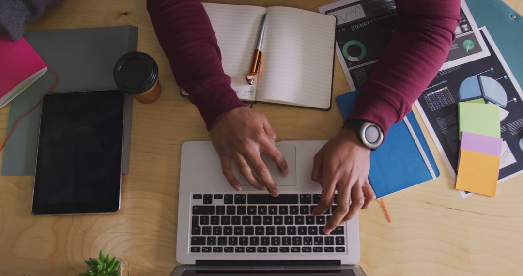 Creative Professional Analyzing Data on Laptop at Modern Workspace
