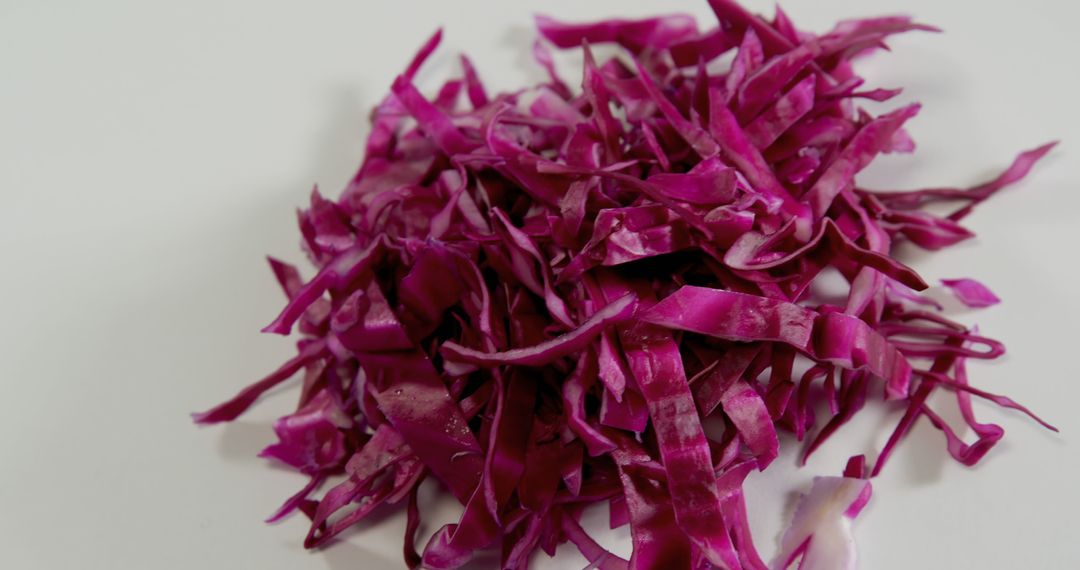 Close-up of fresh shredded purple cabbage on white background - Free Images, Stock Photos and Pictures on Pikwizard.com