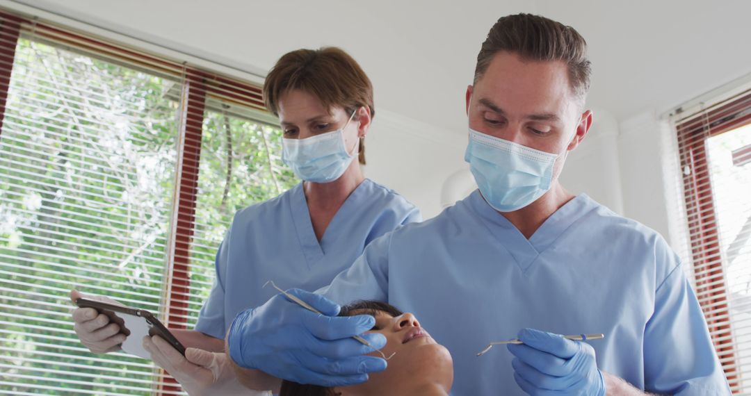 Dentists Performing Examination on Patient with Dental Tools - Free Images, Stock Photos and Pictures on Pikwizard.com