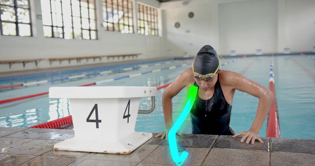 Female Swimmer Emerging from Pool Showing Determination