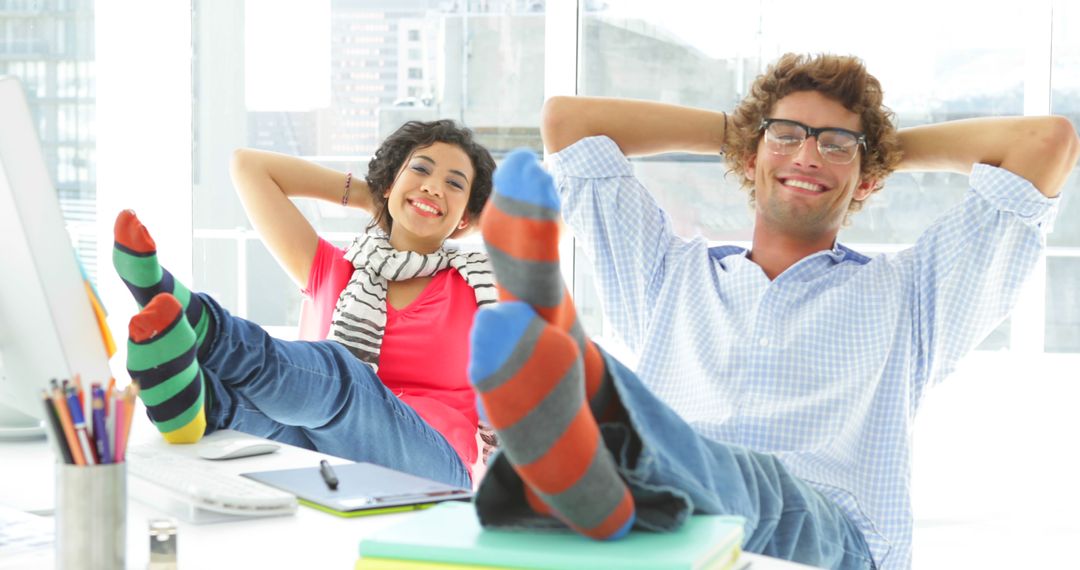 Young Colleagues Relaxing with Bright Socks in Office - Free Images, Stock Photos and Pictures on Pikwizard.com