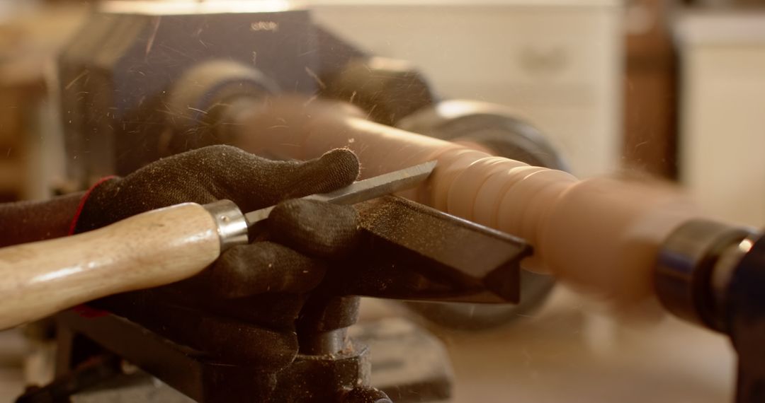 Craftsman Shaping Wooden Cylinder Using Lathe and Chisel in Workshop