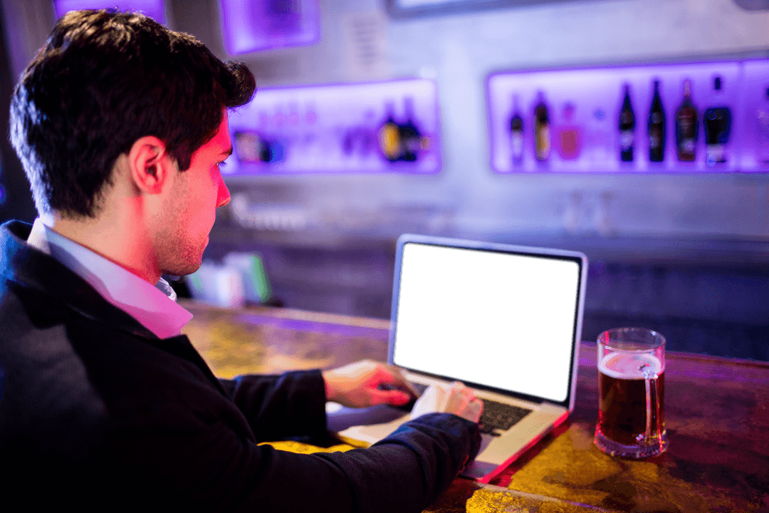 Transparent Laptop Used by Businessman While Sitting in Bar Atmosphere