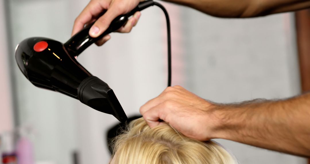 Professional Hairdresser Drying Hair with Hair Dryer in Salon - Free Images, Stock Photos and Pictures on Pikwizard.com