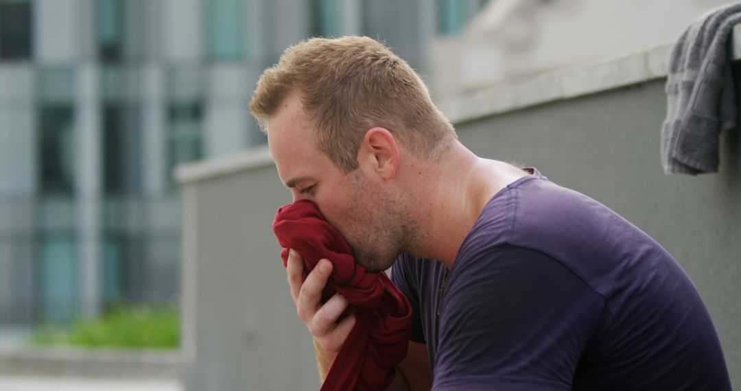 Exhausted Athlete Wiping Face After Intense Workout - Free Images, Stock Photos and Pictures on Pikwizard.com