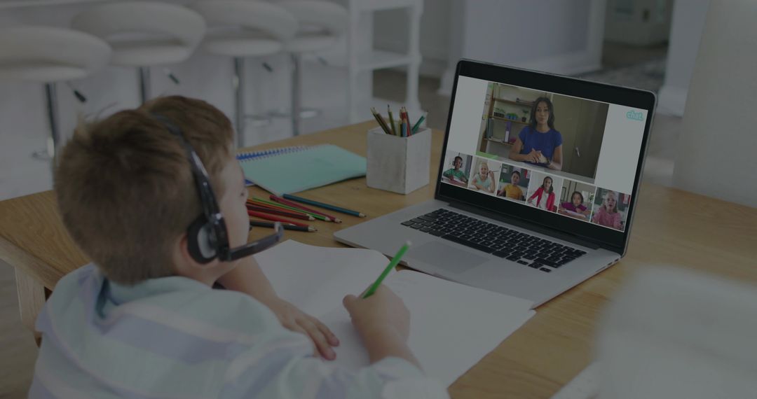 Boy Participating in Virtual Learning Sitting at Kitchen