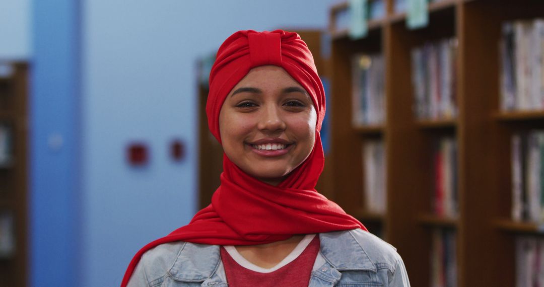 Smiling Woman Wearing Red Hijab in Library - Free Images, Stock Photos and Pictures on Pikwizard.com