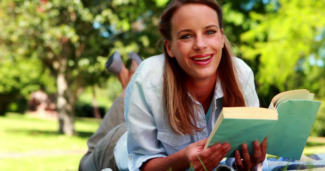 Young Woman Enjoying Book in Sunny Park - Free Images, Stock Photos and Pictures on Pikwizard.com