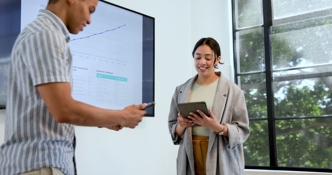Diverse Professionals Collaborating with Technology in Office Meeting