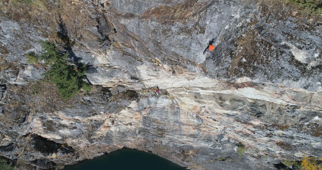 Rock Climbers Scaling Steep Cliff Face in Mountainous Area - Free Images, Stock Photos and Pictures on Pikwizard.com