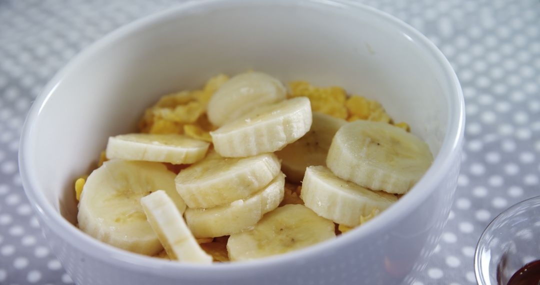 Healthy Breakfast with Fresh Banana Slices and Cornflakes in White Bowl - Free Images, Stock Photos and Pictures on Pikwizard.com