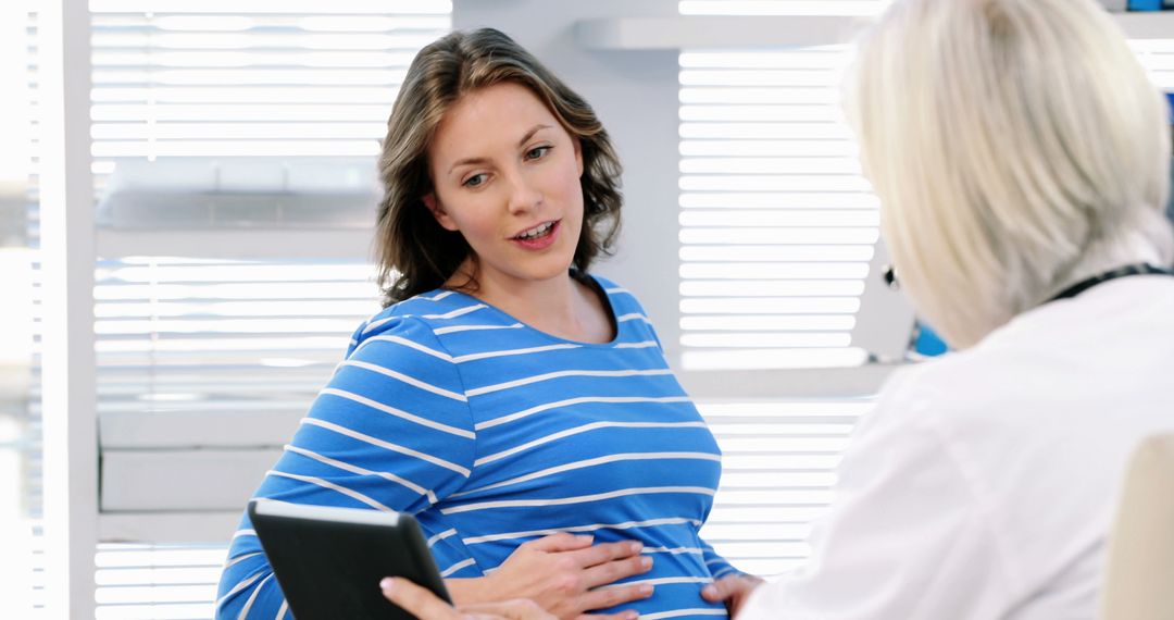 Pregnant Woman Discussing Healthcare with Doctor - Free Images, Stock Photos and Pictures on Pikwizard.com